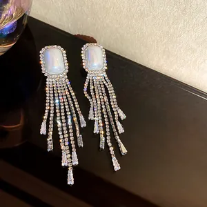 Elegant long silver-toned tassel earrings with shimmering rhinestones and a white stone