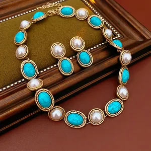 Close-up detail of a vintage turquoise and pearl necklace and earring jewelry set