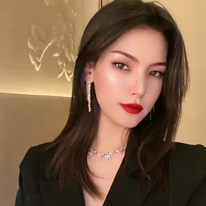 Asian model wearing elegant silver full diamond tassel earrings with sparkling finish