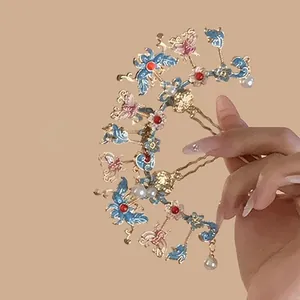 Elegant butterfly and flower hair pin with blue enamel and pearls in a vintage style
