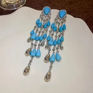 Bohemian long tassel earrings featuring turquoise teardrop beads and sparkling silver accents