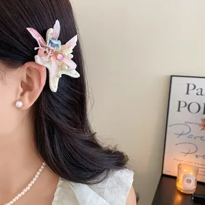 Detailed view of an elegant fabric starfish flower hair clip with rhinestones and pearls