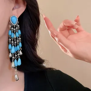 Detail view of turquoise waterdrop tassel earrings in bohemian ethnic style