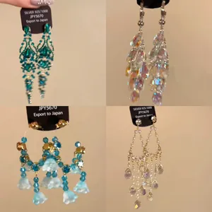 Ethnic style silver needle tassel earrings with rhinestone teardrop designs in four styles.