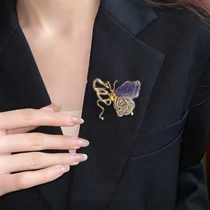 Elegant vintage rhinestone butterfly brooch in gold and purple finish for coat accessory