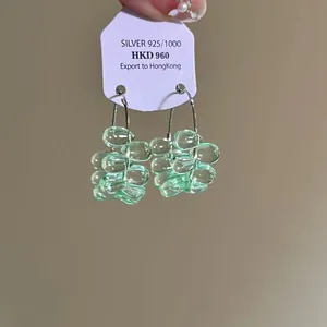 Detailed view of light green glass grape cluster drop earrings with silver 925 hooks