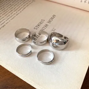 Minimalist 5-piece silver adjustable open ring set with a smooth glossy metallic finish