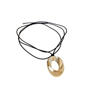 Minimalist gold oval twist pendant necklace with adjustable black cord strap for women