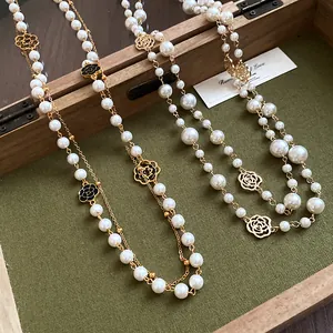 Vintage French style double-layer long necklace featuring pearls and elegant camellia charms