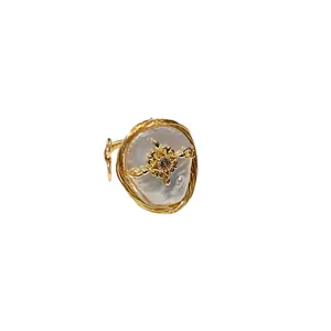Elegant gold plated baroque pearl ring with star zircon detail on white background