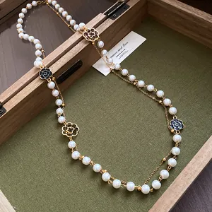 Close-up of vintage French double-layered pearl necklace with camellia charms