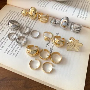 Detailed macro view of minimalist gold and silver metallic open rings on a book