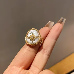 Close-up view of a luxury baroque pearl ring featuring zircon and gold wire wrap