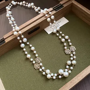 Close-up of vintage French double-layer pearl necklace with rose flower charms