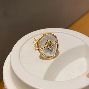 Close-up of an elegant baroque pearl ring with an intricate gold zircon star detail