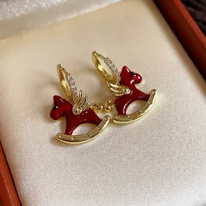 Elegant red enamel rocking horse hoop earrings featuring sparkling zircon stone accents.