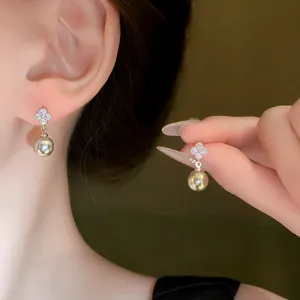 Elegant silver needle zircon flower earrings with dangling grey pearls shown on ear