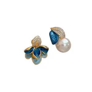 Asymmetrical blue enamel flower and pearl earrings with sparkling rhinestones
