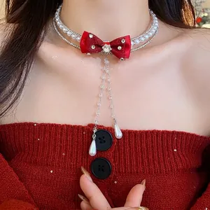 Elegant double-layer pearl choker necklace with red bow and sparkling zircon tassel
