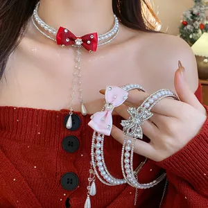 Detailed view of elegant double-layer pearl choker with a silk red bow and zircon accents