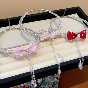 Detailed macro view of zircon pearl butterfly choker necklaces with elegant crystal tassels