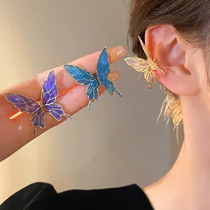 Elegant butterfly drip oil ear cuffs with a blue and purple gradient enamel finish