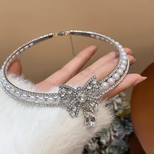 Detailed macro shot of a sparkling rhinestone and pearl butterfly bow choker