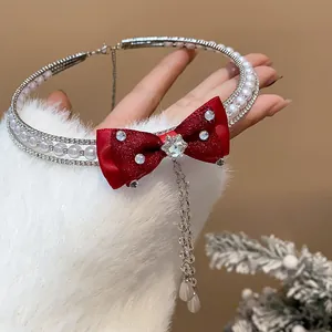 Detail view of a luxury pearl choker featuring a sparkling red bow and star zircon pendant