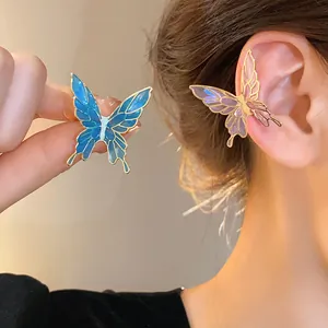 Detailed view of elegant blue and pink butterfly ear cuffs with enamel finish effect