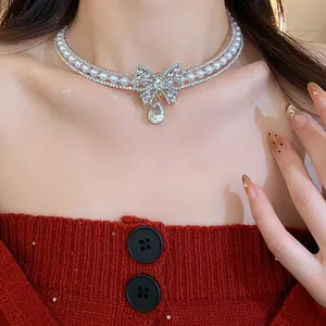 Elegant close-up of a sparkling zircon butterfly and pearl choker necklace on a model