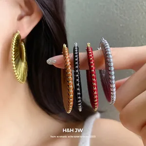 Stylish colorful hollow hoop earrings with textured metallic details for a luxury look