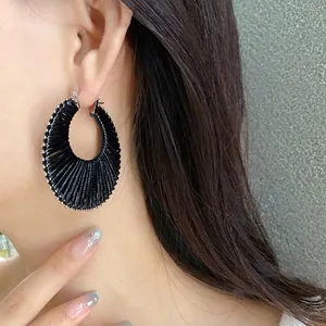 Elegant bohemian style black woven hollow hoop earrings for women with pleated texture