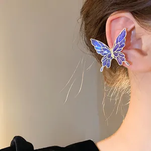 Macro detail of a shimmering purple enamel butterfly ear cuff on an Asian model's ear