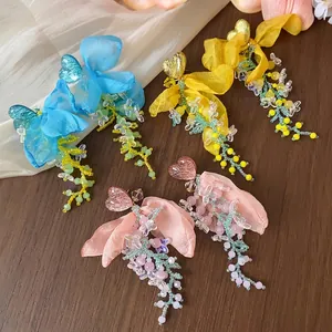 Sweet chiffon flower earrings featuring resin hearts and colorful beaded tassels