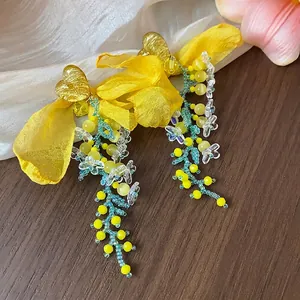 Elegant handmade yellow chiffon flower earrings with golden hearts and beaded dangles