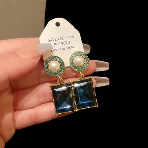 Vintage French style gold earrings with pearls and emerald cut blue gems details