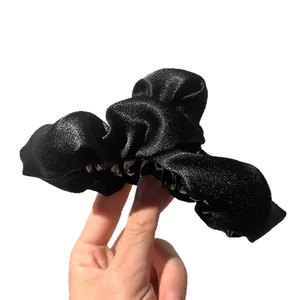 Elegant shimmering black fabric shark hair claw clip for women's versatile hairstyles.