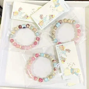 Close-up view of three dopamine colorful ceramic beaded bracelets in individual gift packaging