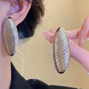 Vintage oversized oval textured silver stud earrings for a sophisticated retro look