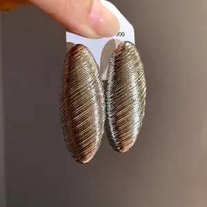 Vintage silver oval textured earrings with a chic metallic wrapped design for women