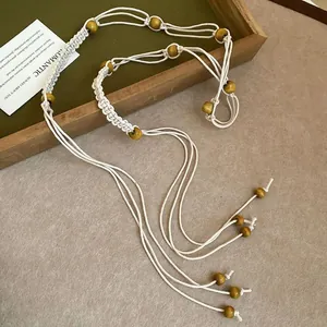 Close-up of ethnic style woven waist chain with decorative wooden beads