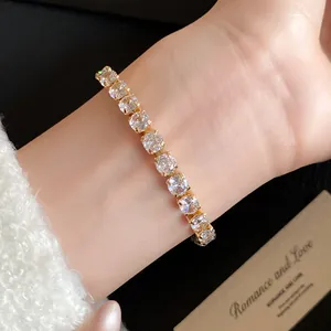 Close-up of a sparkling 18k gold plated cubic zirconia bracelet worn on the wrist