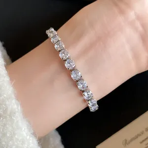 Detailed shot of a luxury 18k gold plated cubic zirconia tennis bracelet on a wrist