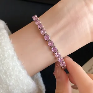 Close-up of elegant pink cubic zirconia bracelet with 18k gold plating on wrist