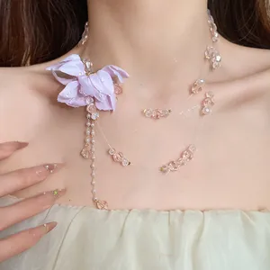 Close-up of double-layer fabric flower necklace with pink crystal beads on model