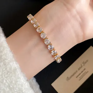 Detailed close-up view of a luxury 18k gold plated tennis bracelet with sparkling zircon stones.
