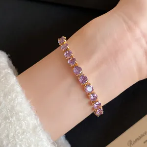Detailed close-up of an 18k gold plated purple zircon square stone bracelet