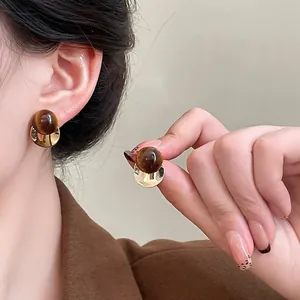 Vintage Maillard style stud earrings with marbled resin spheres and gold-tone curved base