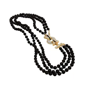 Elegante collana di perle nere multifilo con chiusura dorata con strass vintage