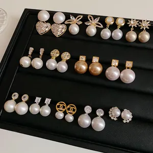 Elegant variety of French vintage pearl earrings displayed in a luxury jewelry tray
